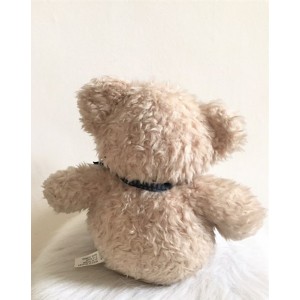 Peluche ourson assis avec noeud